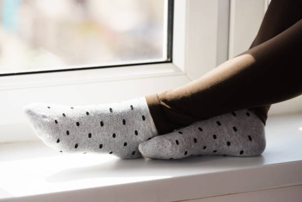 istock Woman wearing grey dotted socks 1193728677