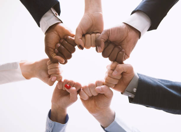 istock Businesspeople fists in circle, view from below 1193728983