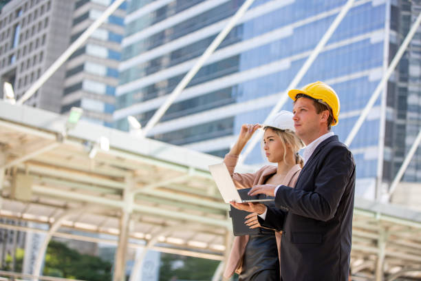 istock Architects Looking Away While Standing Against Building In City 1193729828