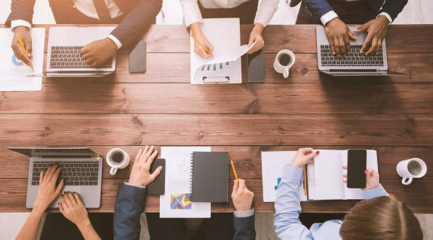 istock Corporate team working at office, with gadgets and documents 1193730147