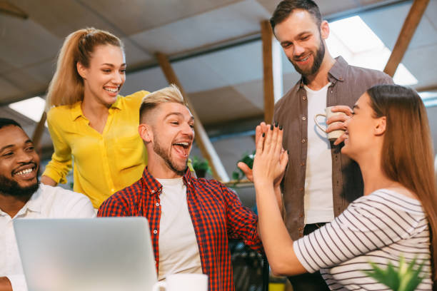 istock Success. Young colleagues giving high five and smiling 1193730394