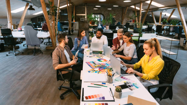 Coworking process. Designers working with project in office Coworking process. Designers working with project in modern office, panorama with free space design occupation stock pictures, royalty-free photos & images