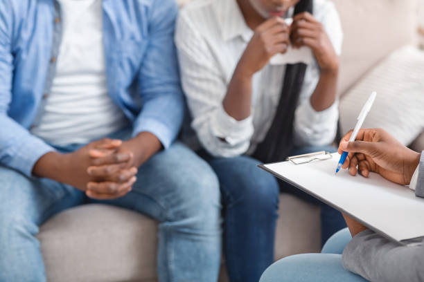 istock Psychologist taking notes on marital therapy session for young afro couple 1193731106