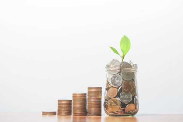 istock coins in glass bottle on the table 1193732353