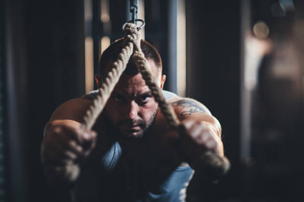 istock Man exercising alone in dark gym 1193733128