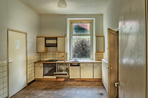 Kitchen under the window in abandoned farmhouse.