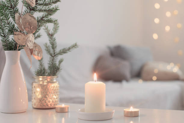 istock Christmas decorations with burning candles in white interior 1193734936