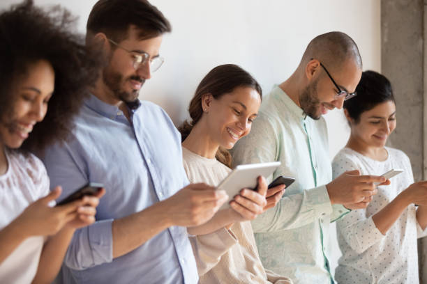 istock Addicted to technology group of mixed race students using devices. 1193735011