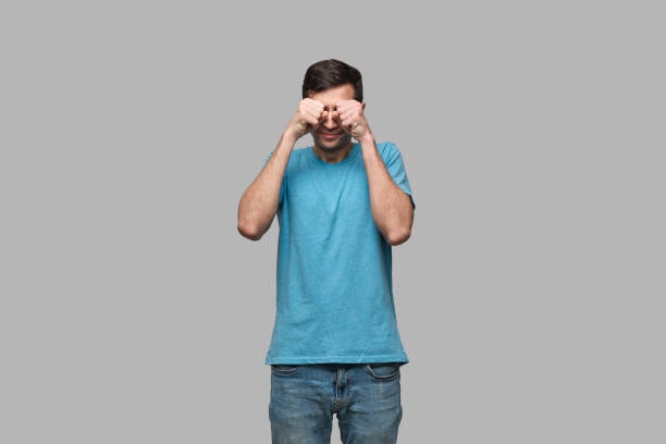 young brunet man rubbing eyes isolated over grey background. being tired after long working day. - clock clock face blank isolated imagens e fotografias de stock