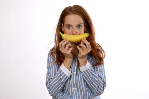 istock Redhead woman in striped blouse with fruit in studio 1193736395