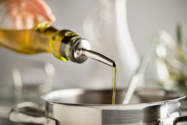 istock Cooking oil pouring in to pot 1193736436