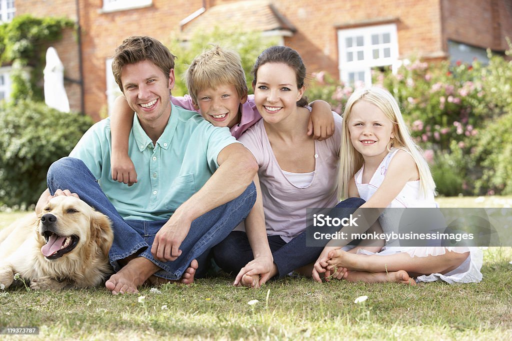 Family Sitting In Garden Together  Family Stock Photo