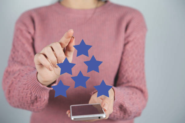 istock woman hand stars icon in screen 1193744985