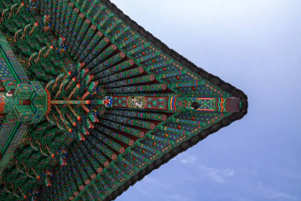 Photo of The roof and blue sky of a Korean Buddhist temple