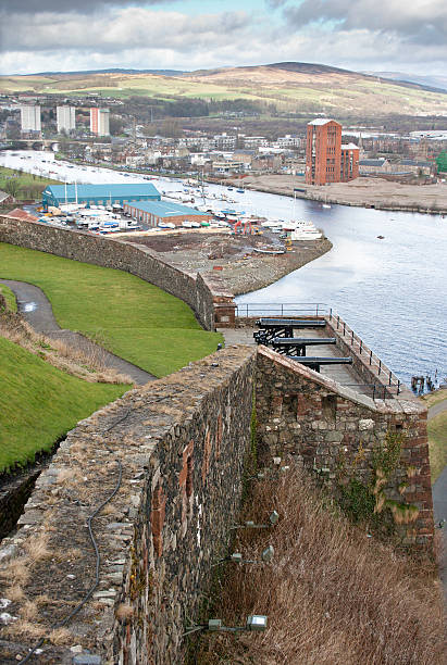 Dumbarton and Castle Shot of the former industrial town of Dumbarton in Scotland - view taken from Dumbarton Castle. dumbarton castle stock pictures, royalty-free photos & images