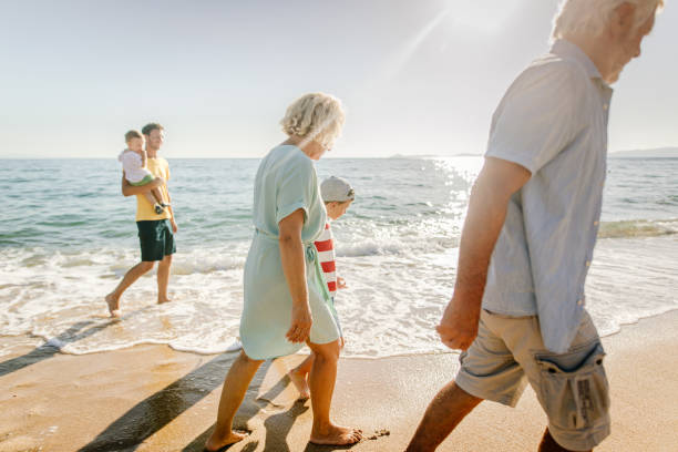 istock Three generations family in a walk by the sea 1193748086