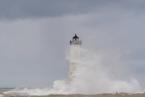 istock Breaking waves swirl aound the Frankfort North Breakwater Lighthouse 1193748104