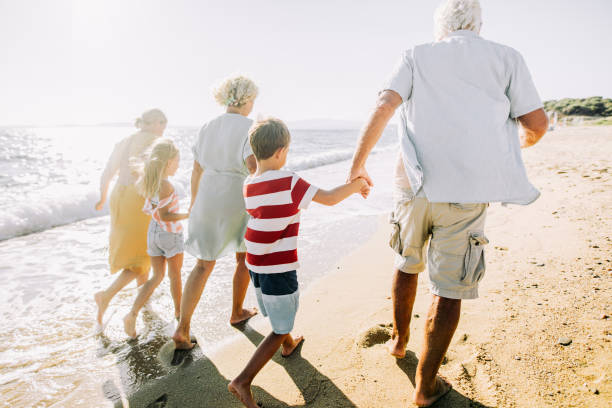 istock Three generations family in a walk by the sea 1193748650