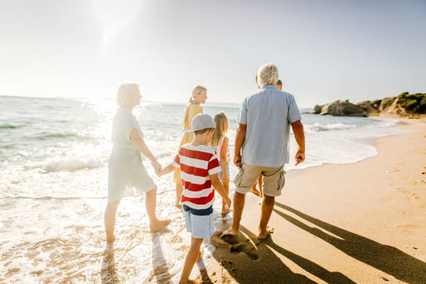istock Three generations family in a walk by the sea 1193748652