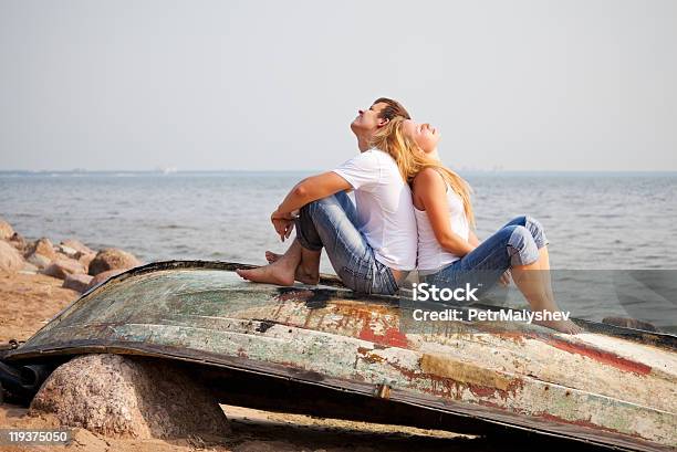 Couple Sitting On Old Boat Stock Photo - Download Image Now - Adult, Adults Only, Back