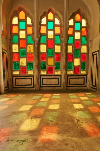 Stained glass window - Vitrage. Indian or arabic window pattern. Red green and yellow painted windows. Hawa Mahal or Palace of Winds, Jaipur, India. 30.11.2019