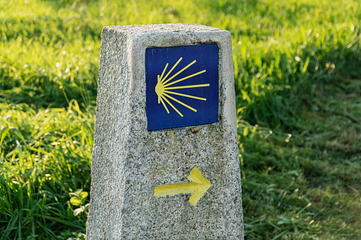 Way of St. James sign. Yellow scallop sign pilgrimage to Santiago de Compostela. Outdoor