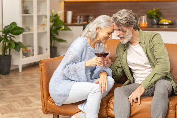 istock Two people holding wineglasses in their hands 1193752564
