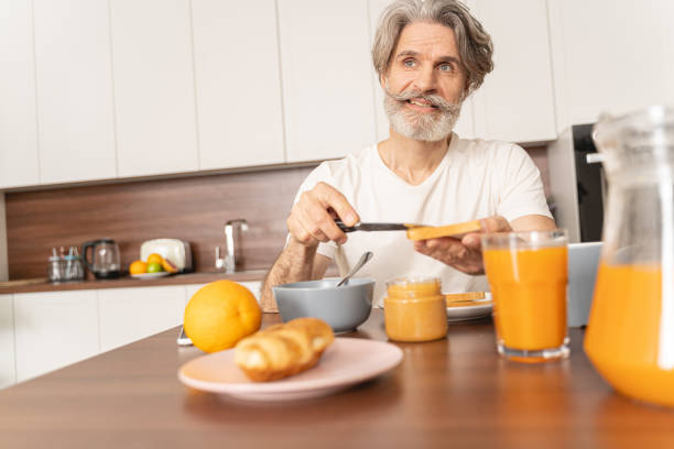 istock Man spreading peanut butter with a knife 1193752659