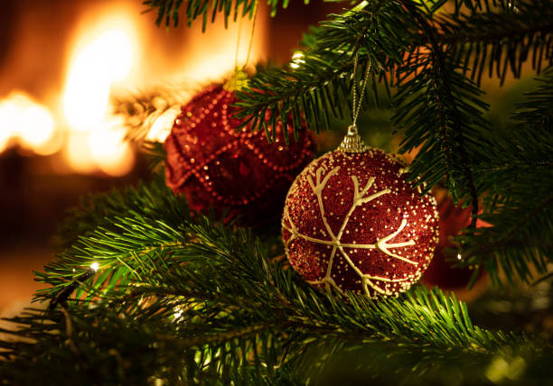 istock Christmas tree close up on blur glowing fire background 1193753723