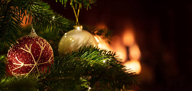 istock Christmas tree close up on blur glowing fire background 1193753729