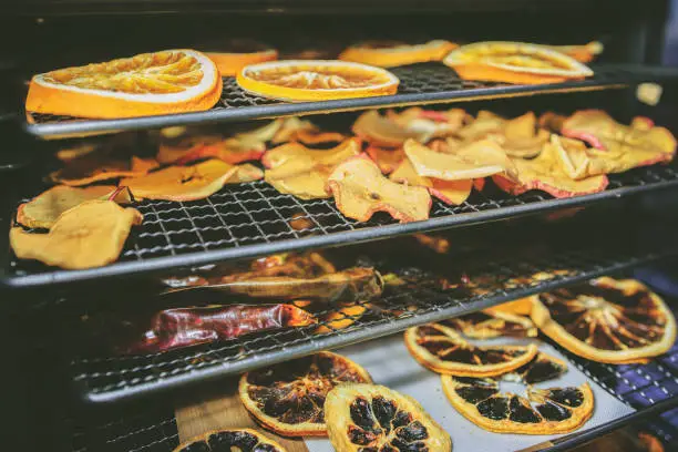 Concept of healthy home cooking - drying the fruit in the oven during the winter and holiday season (reduced tones)