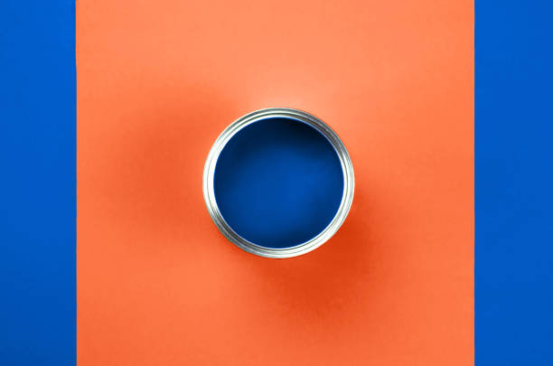 istock A can of blue paint on a coral blue background. 1193754884