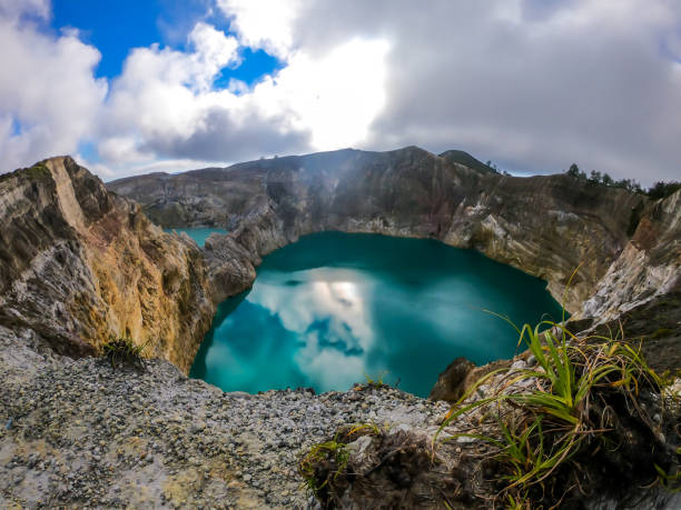 istock Kelimutu - Turquoise colored volcanic lake 1193754993