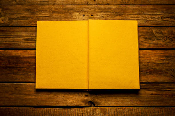 istock Old blank open book on wooden background from above 1193761962