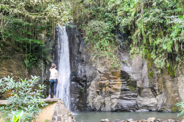 istock Moni - A girl standing in front of a waterfall 1193767975