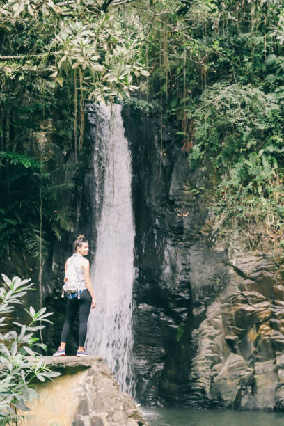 istock Moni - A girl standing in front of a waterfall 1193767998