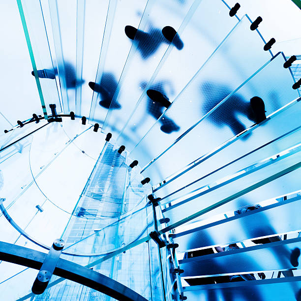 istock View of feet from below a modern translucent glass staircase 119376831