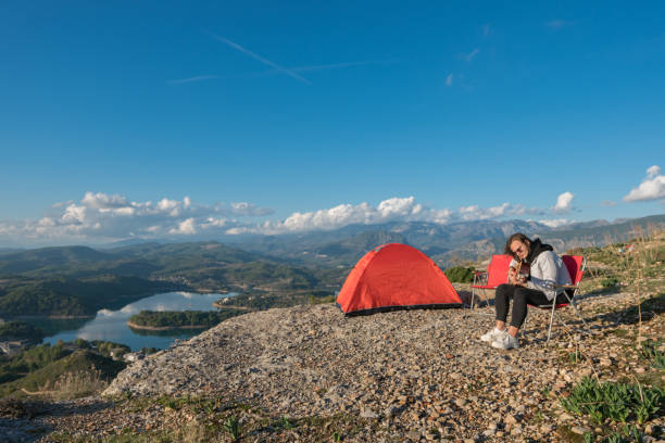 istock Man camping on the mountains singing and playing guitar. 1193772887