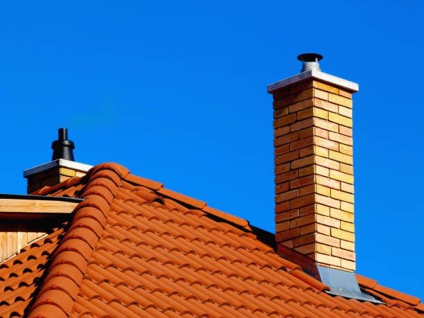 yellow brick chimney and light brown clay tile roof stock photo