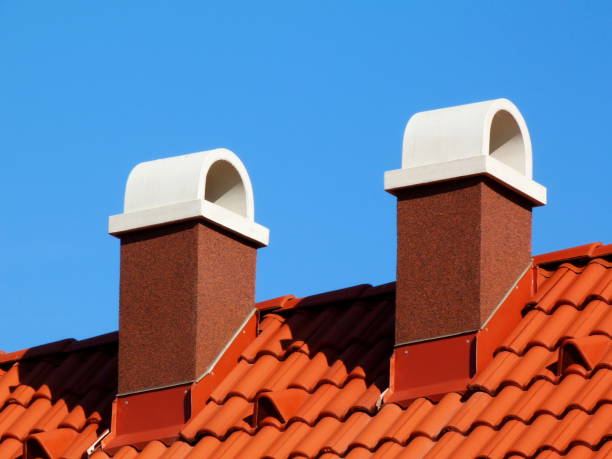 istock textured brown stucco finished chimneys with white ceramic cap stone 1193773018