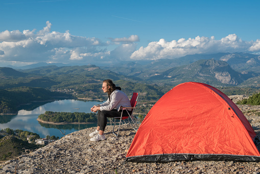 Man traveling with backpack camping in mountains