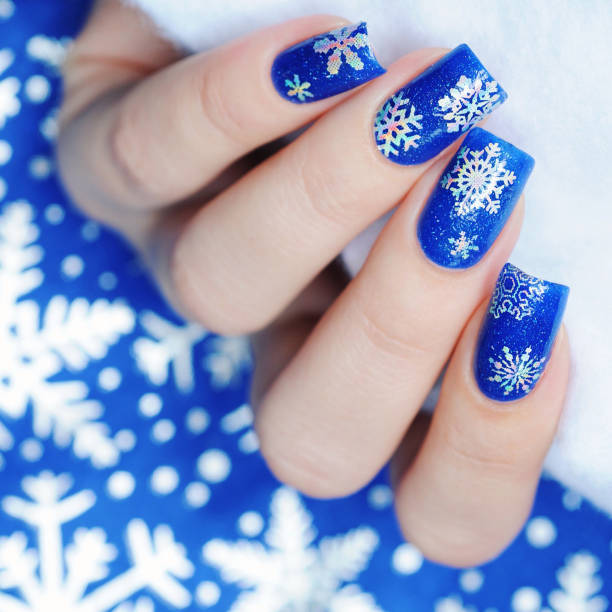 istock Christmas winter blue manicure with a snowflakes 1193776011