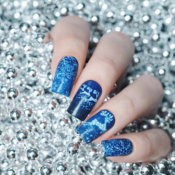 istock Christmas manicure with a deer and snowflakes 1193776054