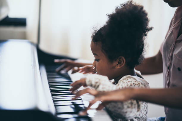 istock Mother is teaching piano tricks, African people 1193778429