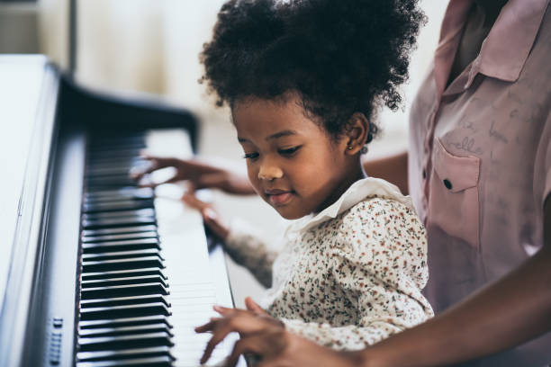 istock Mother is teaching piano tricks, African people 1193778637