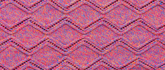 Knitted sweater texture. Pink melange rhombus pattern. Background. Banner. Copy space