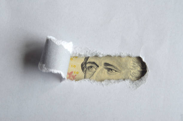 istock Eyes of Alexander Hamilton behind torn paper 1193780021