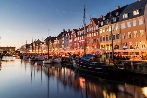 Nyhavn water front canal and touristic street at night in Copenhagen