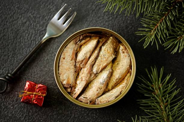 istock Baltic sprats in an iron can on a black background. 1193782066
