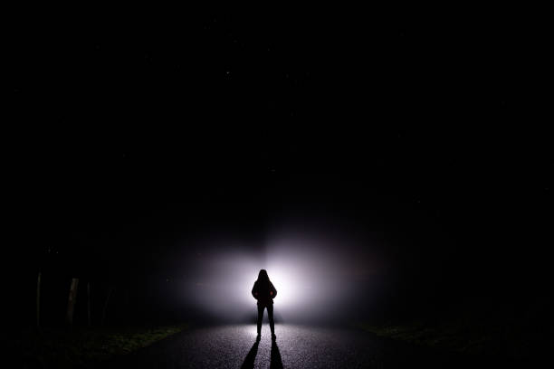 Ghostly, mystical, surreal person standing in darkness